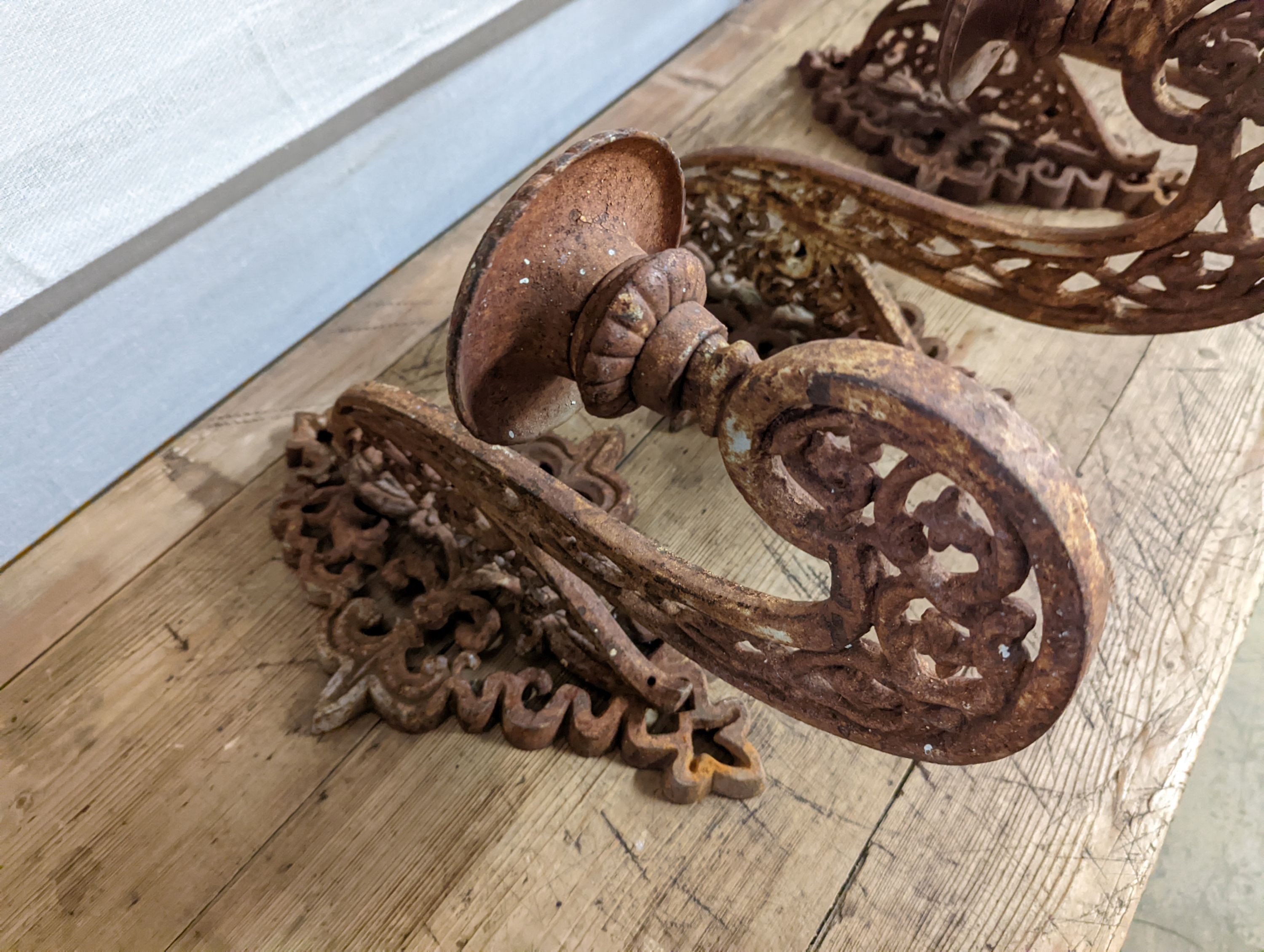 Three cast iron pricket wall sconces. W-28cm.